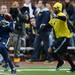 Former Michigan football player Jason Eldridge receives a pass around Lasker Smith during the annual alumni flag football game before spring practice at Michigan Stadium on Saturday, April 13, 2013. Melanie Maxwell I AnnArbor.com